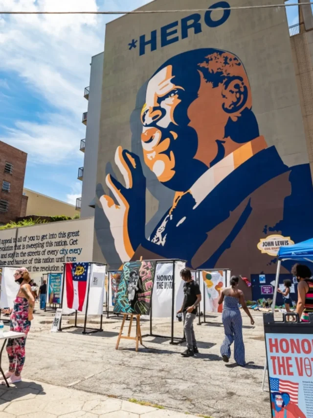 Mural of John Lewis with HERO caption during a voting rights event